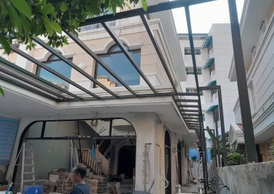 Wide view of metal structure installation for roof awning at a residential house