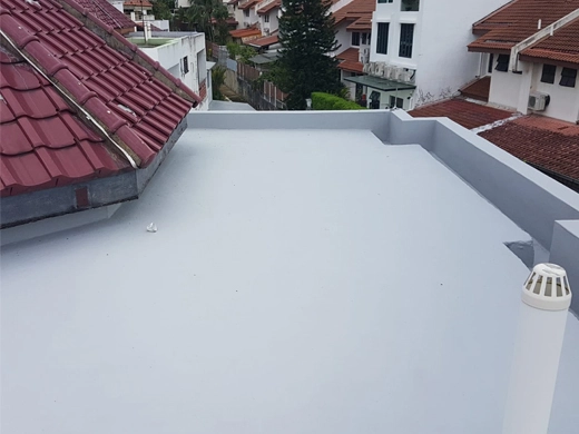 Employee applying sheet membrane waterproof coating on a roof with equipments